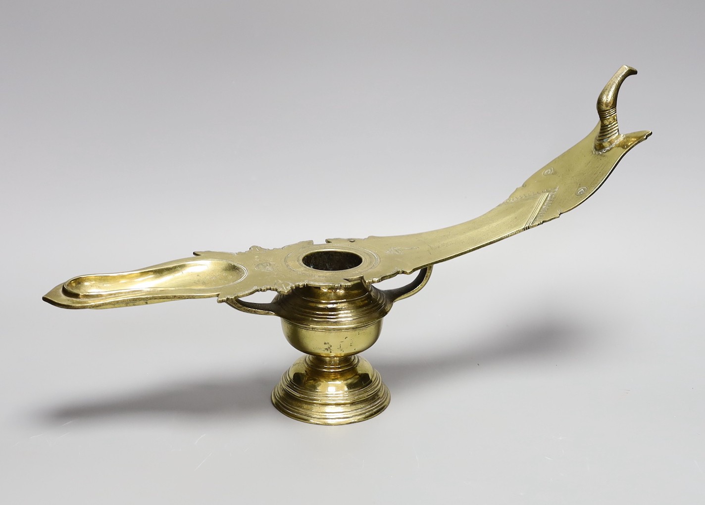 A 19th century Indian brass oil lamp, 45 cms wide